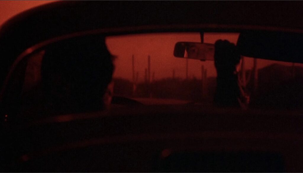 Richard Gere som kjører i solnedgang frå filmen Breathless 1983.